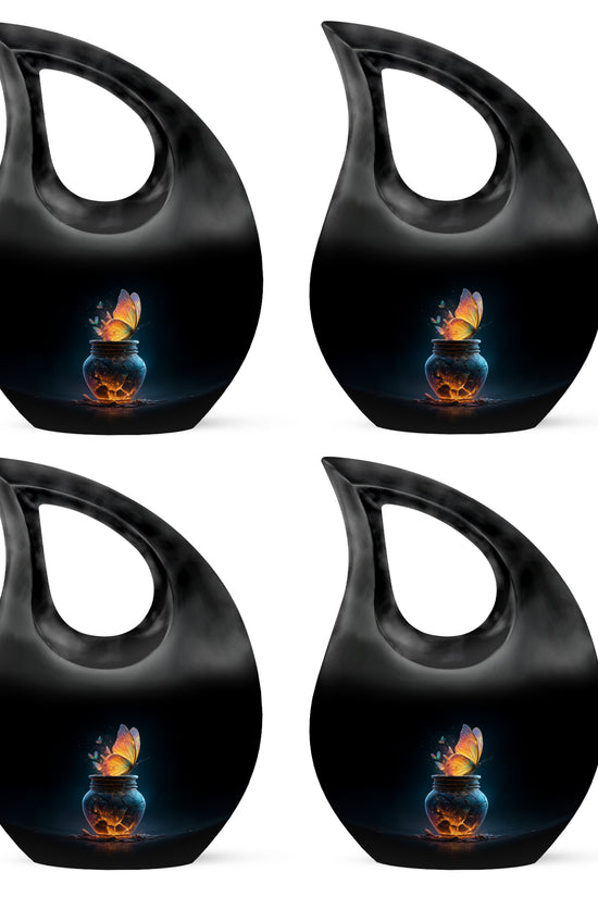 Charcoal Black Butterfly Cremation Urn lifestyle display on memorial shelf - faith-inspired cross-drop urn with butterfly pattern - 10 inch aluminum urn for cremated remains