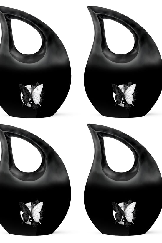 Obsidian Black Butterfly Cremation Urn lifestyle display on memorial shelf - faith-inspired cross-drop urn with butterfly pattern - 10 inch aluminum urn for cremated remains