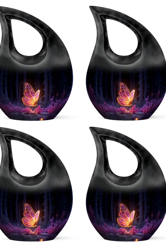 Rich Black Butterfly Cremation Urn lifestyle display on memorial shelf - sacred cross merged with butterfly motif on metal - 10 inch aluminum urn for cremated remains