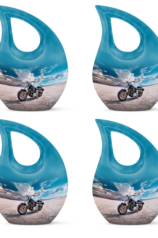 Indigo Bike Cremation Urn lifestyle display on memorial shelf - sacred cross merged with bike motif on metal - 10 inch aluminum urn for cremated remains