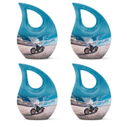 Indigo Bike Cremation Urn lifestyle display on memorial shelf - sacred cross merged with bike motif on metal - 10 inch aluminum urn for cremated remains