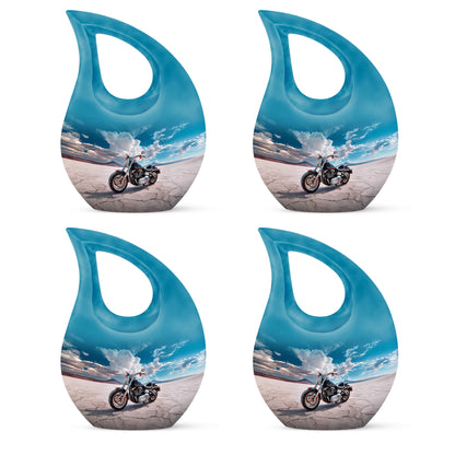Indigo Bike Cremation Urn lifestyle display on memorial shelf - sacred cross merged with bike motif on metal - 10 inch aluminum urn for cremated remains