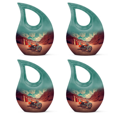 Jewel Teal Bike Cremation Urn lifestyle display on memorial shelf - cross and bike combined in spiritual memorial design - 10 inch aluminum urn for cremated remains