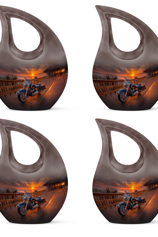 Deep Black Bike Cremation Urn lifestyle display on memorial shelf - sacred cross merged with bike motif on metal - 10 inch aluminum urn for cremated remains