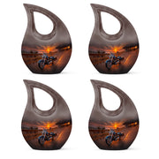 Deep Black Bike Cremation Urn lifestyle display on memorial shelf - sacred cross merged with bike motif on metal - 10 inch aluminum urn for cremated remains