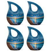 Icy Blue Beach Cremation Urn lifestyle display on memorial shelf - sacred cross merged with beach motif on metal - 10 inch aluminum urn for cremated remains