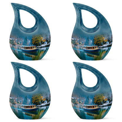 Powder Blue Boat Cremation Urn lifestyle display on memorial shelf - sacred cross merged with boat motif on metal - 10 inch aluminum urn for cremated remains