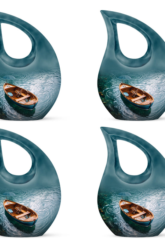 Jewel Teal Boat Cremation Urn lifestyle display on memorial shelf - cross and boat combined in spiritual memorial design - 10 inch aluminum urn for cremated remains