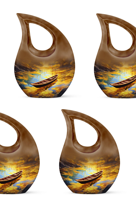 Antique Gold Boat Cremation Urn lifestyle display on memorial shelf - sacred cross merged with boat motif on metal - 10 inch aluminum urn for cremated remains