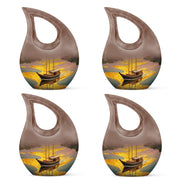 Champagne Gold Boat Cremation Urn lifestyle display on memorial shelf - sacred cross merged with boat motif on metal - 10 inch aluminum urn for cremated remains