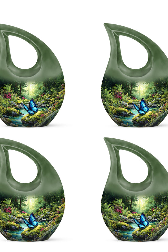 Emerald Green Butterfly Cremation Urn lifestyle display on memorial shelf - sacred cross merged with butterfly motif on metal - 10 inch aluminum urn for cremated remains