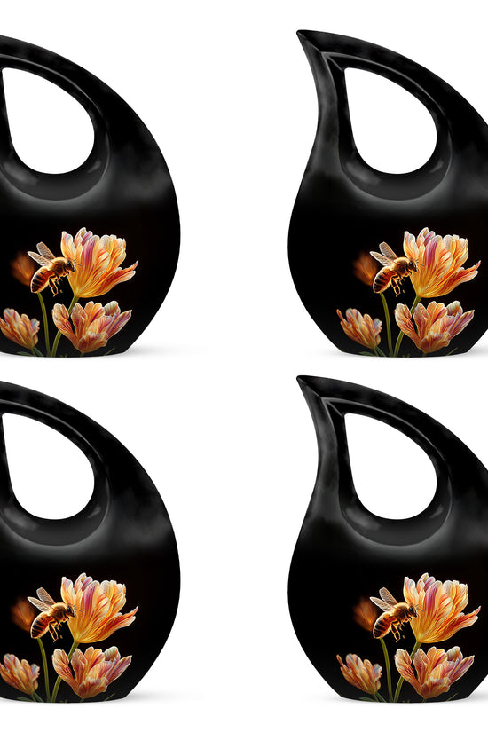 Rich Black Bee Cremation Urn lifestyle display on memorial shelf - sacred cross merged with bee motif on metal - 10 inch aluminum urn for cremated remains