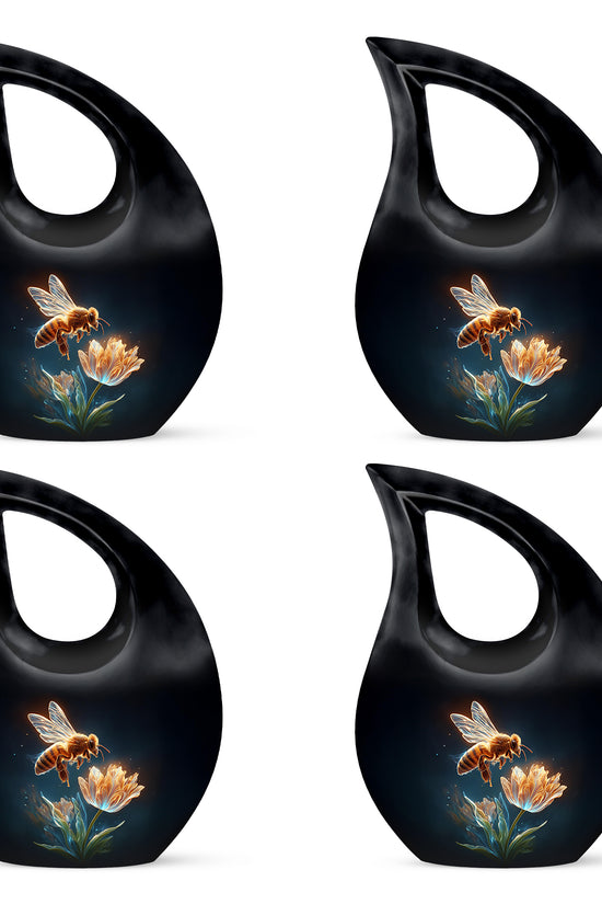Glossy Black Bee Cremation Urn lifestyle display on memorial shelf - cross and bee combined in spiritual memorial design - 10 inch aluminum urn for cremated remains