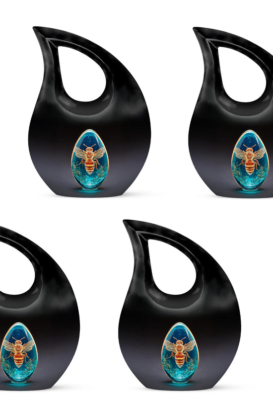 Deep Black Bee Cremation Urn lifestyle display on memorial shelf - cross and bee combined in spiritual memorial design - 10 inch aluminum urn for cremated remains