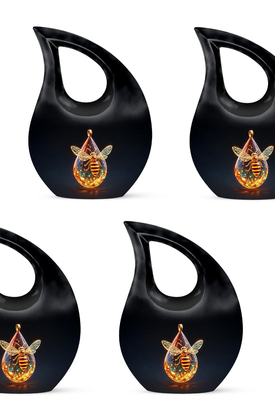 Midnight Black Bee Cremation Urn lifestyle display on memorial shelf - devotional cross-drop bee engraving - 10 inch aluminum urn for cremated remains