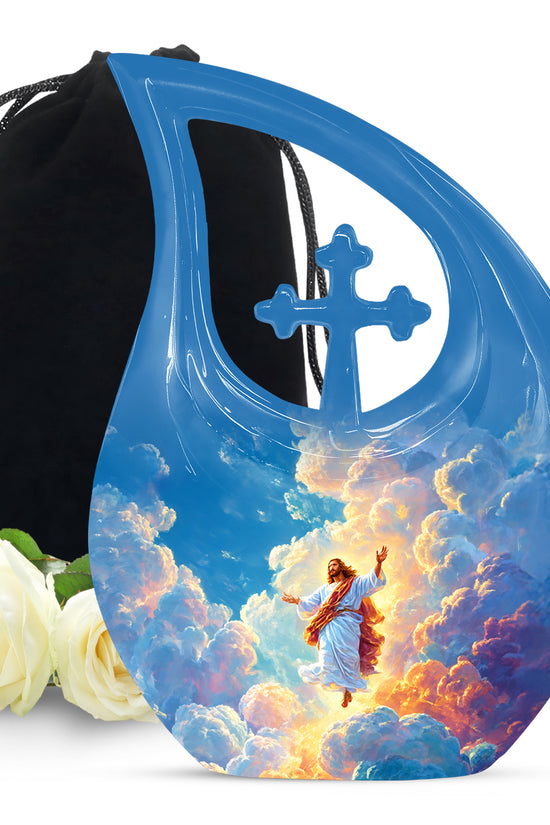 Decorative urn with angel design, cross, and roses on a white background