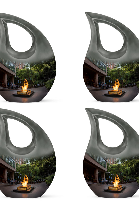 Charcoal Black Campfire Cremation Urn lifestyle display on memorial shelf - faith-inspired cross-drop urn with campfire pattern - 10 inch aluminum urn for cremated remains