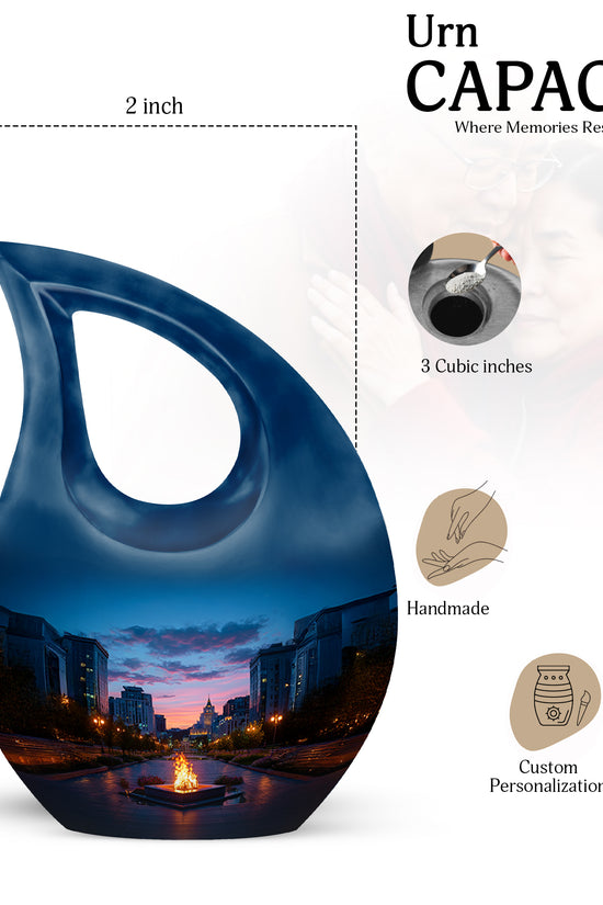 Misty Blue Campfire Cremation Urn back view with polished surface - sacred cross merged with campfire motif on metal - mini keepsake memorial for portion of cremation ashes