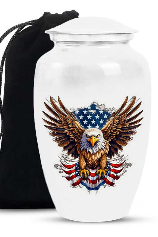 White urn with an eagle and American flag design, accompanied by a black drawstring bag.