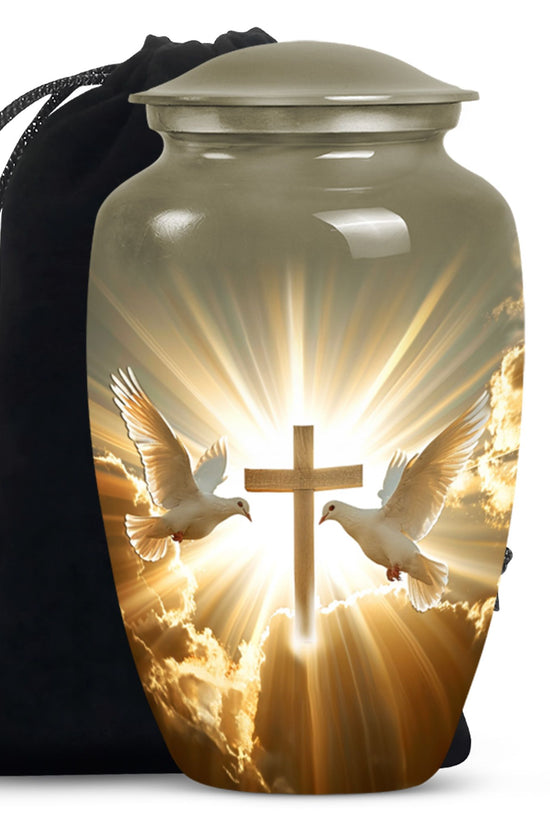 Cremation urn with a cross and two white doves design, accompanied by a black carrying bag.