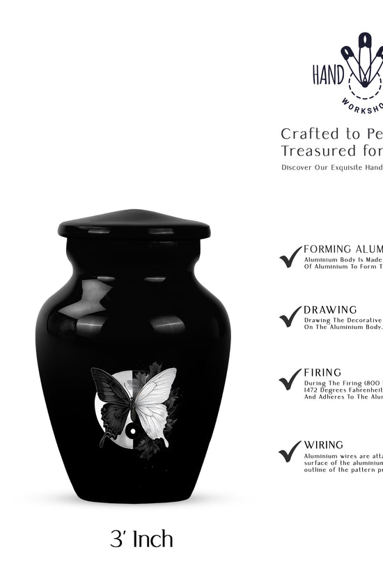 Glossy Black Butterfly Cremation Urn close-up of engraving and surface detail - classic sculpted butterfly pattern on smooth aluminum - mini keepsake memorial for portion of cremation ashes