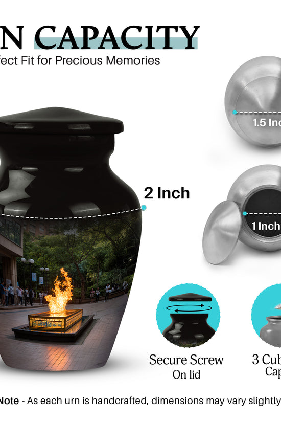 Glossy Black Campfire Cremation Urn close-up of engraving and surface detail - classic sculpted campfire pattern on smooth aluminum - mini keepsake memorial for portion of cremation ashes