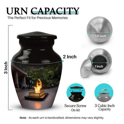 Glossy Black Campfire Cremation Urn close-up of engraving and surface detail - classic sculpted campfire pattern on smooth aluminum - mini keepsake memorial for portion of cremation ashes