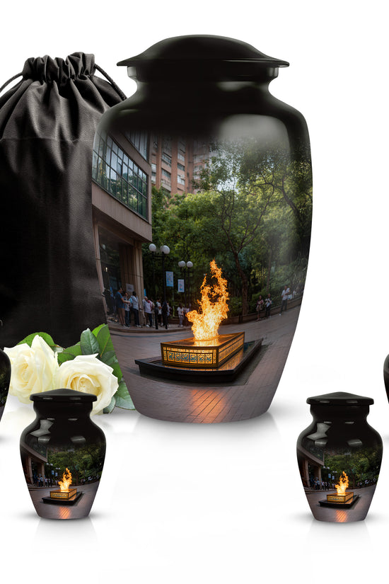 Glossy Black Campfire Cremation Urn top-down view of secure threaded lid - timeless campfire motif etched into premium metal - memorial set with one large and four small urns