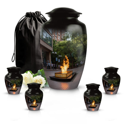 Glossy Black Campfire Cremation Urn top-down view of secure threaded lid - timeless campfire motif etched into premium metal - memorial set with one large and four small urns