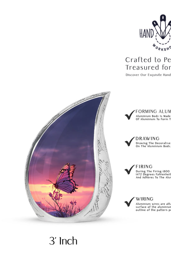 Soft Blue Butterfly Cremation Urn angled view of lid and engraved motif - smooth teardrop contour featuring butterfly art - mini keepsake memorial for portion of cremation ashes
