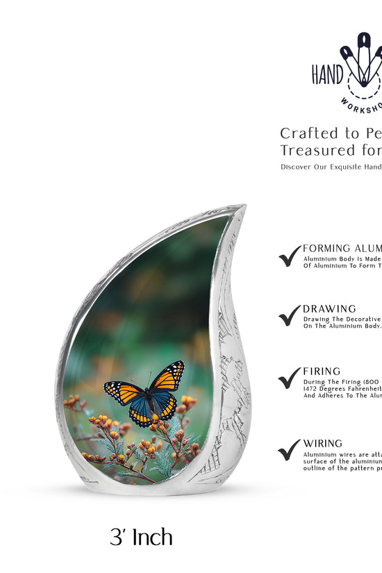 Mint Green Butterfly Cremation Urn angled view of lid and engraved motif - smooth teardrop contour featuring butterfly art - mini keepsake memorial for portion of cremation ashes