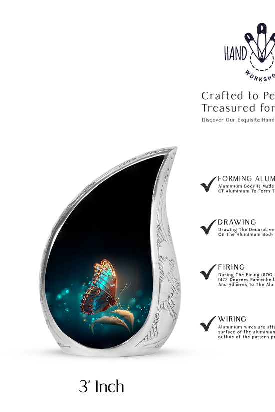 Ebony Butterfly Cremation Urn angled view of lid and engraved motif - flowing teardrop butterfly silhouette on curved aluminum - mini keepsake memorial for portion of cremation ashes