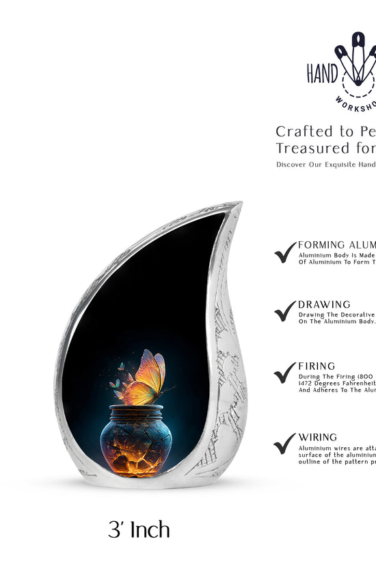 Onyx Black Butterfly Cremation Urn angled view of lid and engraved motif - smooth teardrop contour featuring butterfly art - mini keepsake memorial for portion of cremation ashes