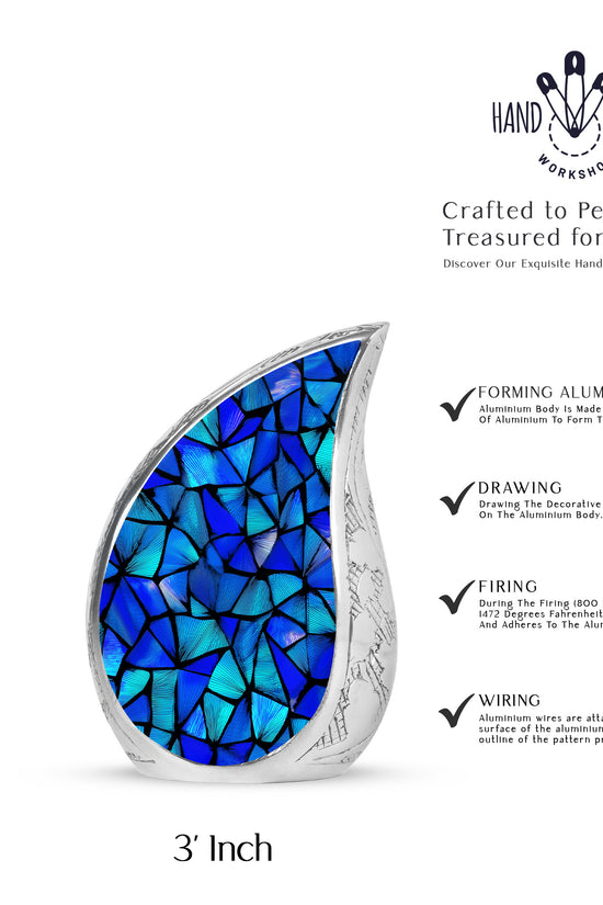 Dusty Blue Blue Cremation Urn angled view of lid and engraved motif - rounded teardrop blue design with delicate detail - mini keepsake memorial for portion of cremation ashes