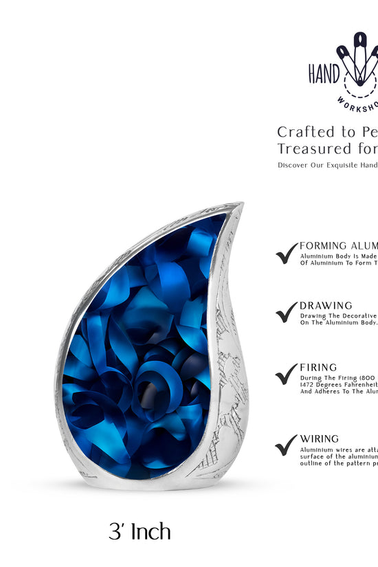Glossy Black Blue Cremation Urn angled view of lid and engraved motif - flowing teardrop blue silhouette on curved aluminum - mini keepsake memorial for portion of cremation ashes