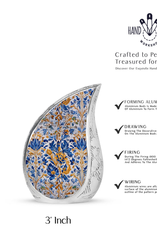 Steel Gray Blue Cremation Urn angled view of lid and engraved motif - smooth teardrop contour featuring blue art - mini keepsake memorial for portion of cremation ashes