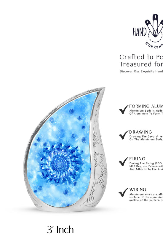 Soft Blue Blue Cremation Urn angled view of lid and engraved motif - graceful tear-shaped urn with blue motif - mini keepsake memorial for portion of cremation ashes