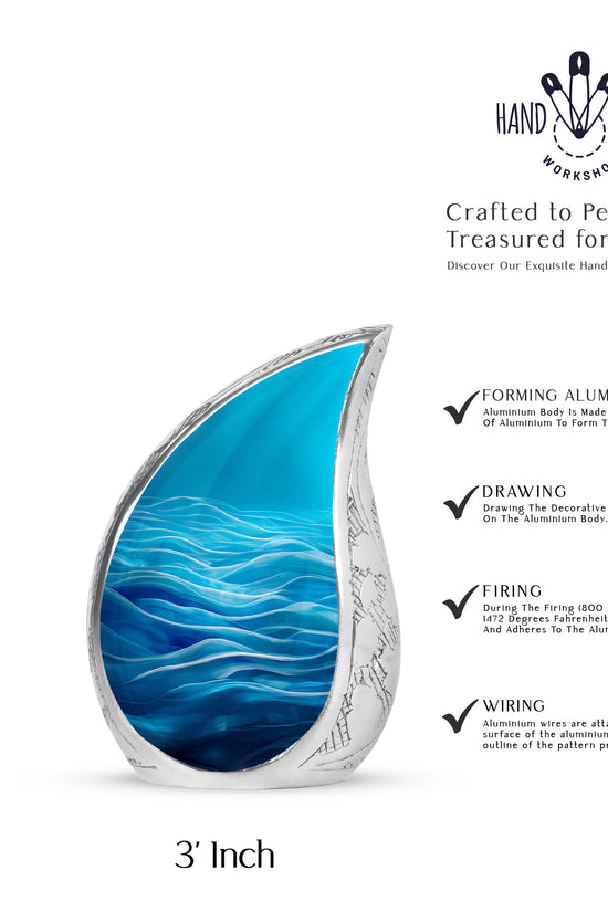 Pastel Blue Blue Cremation Urn angled view of lid and engraved motif - flowing teardrop blue silhouette on curved aluminum - mini keepsake memorial for portion of cremation ashes