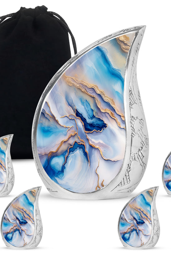 Indigo Blue Cremation Urn side profile showing urn shape - flowing teardrop blue silhouette on curved aluminum - memorial set with one large and four small urns
