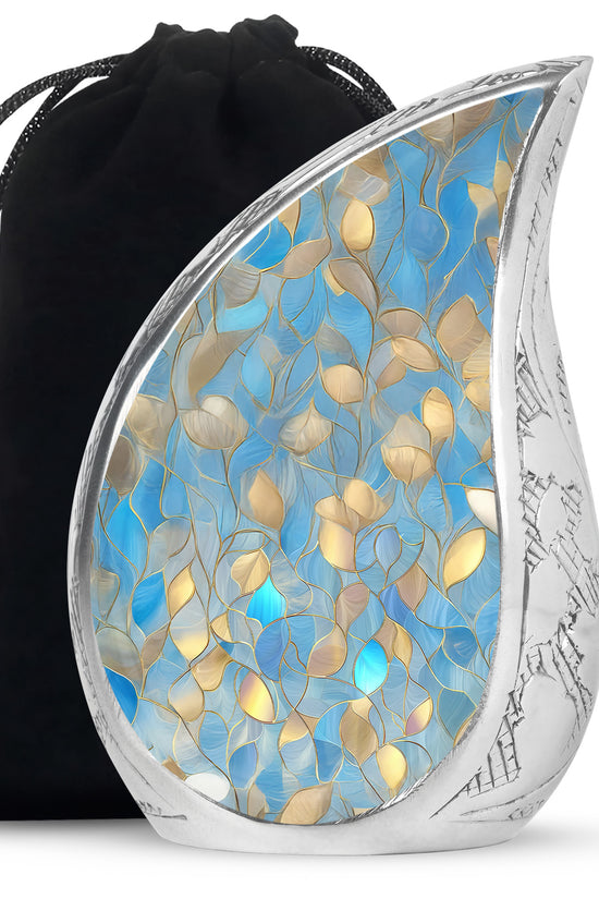 Indigo Blue Cremation Urn front view showing detailed design - flowing teardrop blue silhouette on curved aluminum - full-size 10 inch 200 cubic inch adult cremation urn
