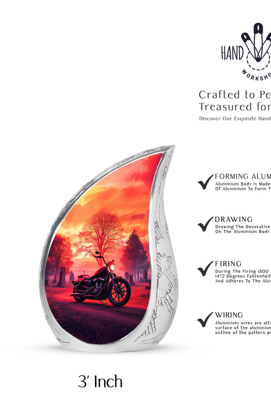 Ruby Red Bike Cremation Urn angled view of lid and engraved motif - graceful tear-shaped urn with bike motif - mini keepsake memorial for portion of cremation ashes
