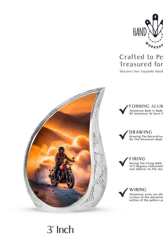 Warm Gold Bike Cremation Urn angled view of lid and engraved motif - graceful tear-shaped urn with bike motif - mini keepsake memorial for portion of cremation ashes