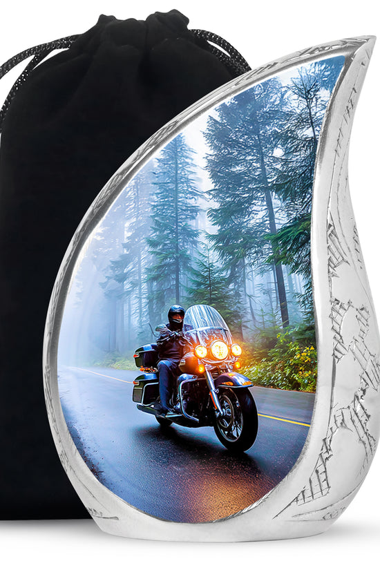 Indigo Bike Cremation Urn front view showing detailed design - flowing teardrop bike silhouette on curved aluminum - full-size 10 inch 200 cubic inch adult cremation urn