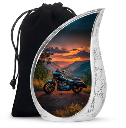 Azure Bike Cremation Urn front view showing detailed design - flowing teardrop bike silhouette on curved aluminum - full-size 10 inch 200 cubic inch adult cremation urn