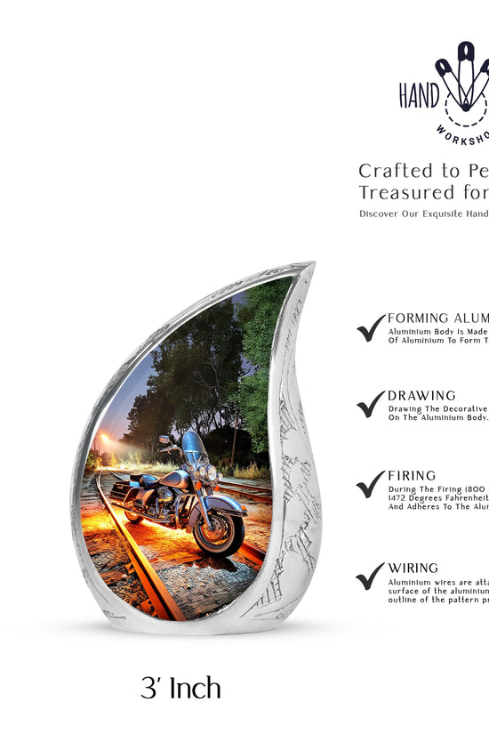 Navy Blue Bike Cremation Urn angled view of lid and engraved motif - flowing teardrop bike silhouette on curved aluminum - mini keepsake memorial for portion of cremation ashes