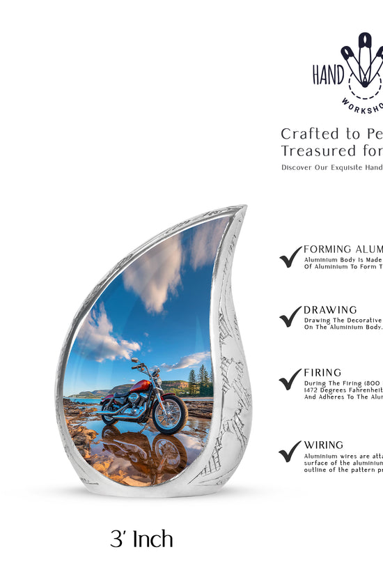 Royal Blue Bike Cremation Urn angled view of lid and engraved motif - graceful tear-shaped urn with bike motif - mini keepsake memorial for portion of cremation ashes