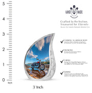 Royal Blue Bike Cremation Urn angled view of lid and engraved motif - graceful tear-shaped urn with bike motif - mini keepsake memorial for portion of cremation ashes
