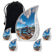Steel Blue Bike Cremation Urn side profile showing urn shape - smooth teardrop contour featuring bike art - memorial set with one large and four small urns