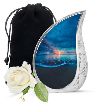 Pastel Blue Beach Cremation Urn front view showing detailed design - flowing teardrop beach silhouette on curved aluminum - full-size 10 inch 200 cubic inch adult cremation urn