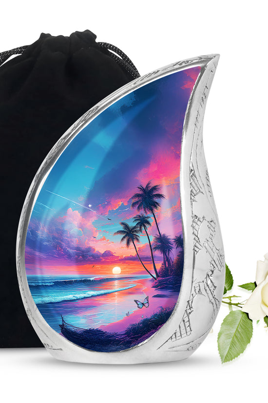 Indigo Beach Cremation Urn front view showing detailed design - flowing teardrop beach silhouette on curved aluminum - full-size 10 inch 200 cubic inch adult cremation urn